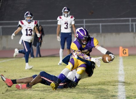 Lemoore's Lucas Jensen stretches the ball across the goal line for a score in Friday night's playoff game against Justin Garza.
